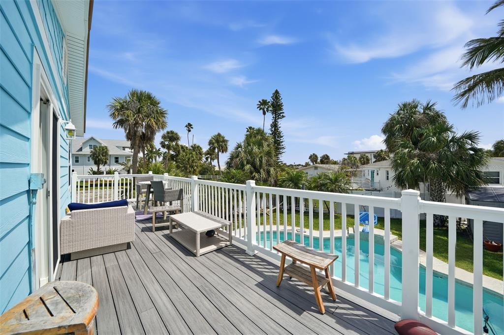 15823 Redington Drive Redington Beach, FL 33708 - Photo 17 of 39 a view of a balcony with wooden floor and outdoor seating