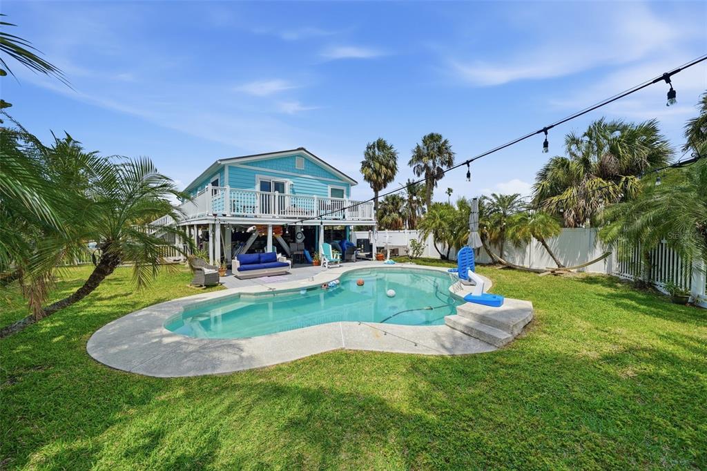 15823 Redington Drive Redington Beach, FL 33708 - Photo 2 of 39 a front view of a house with garden