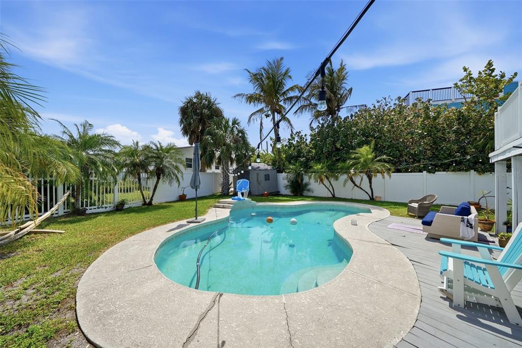 15823 Redington Drive Redington Beach, FL 33708 - Photo 25 of 39 a view of a swimming pool with a yard and plants