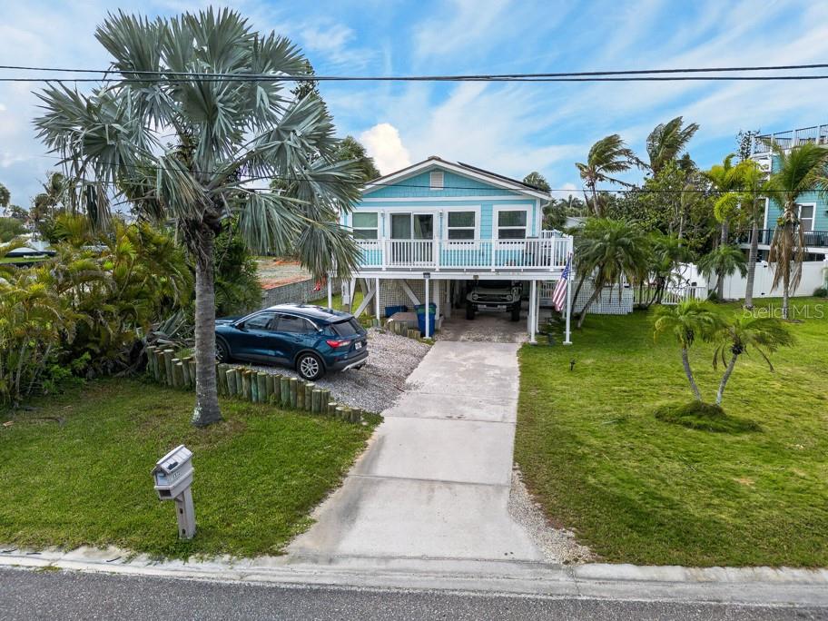 15823 Redington Drive Redington Beach, FL 33708 - Photo 27 of 39 a front view of a house with garden