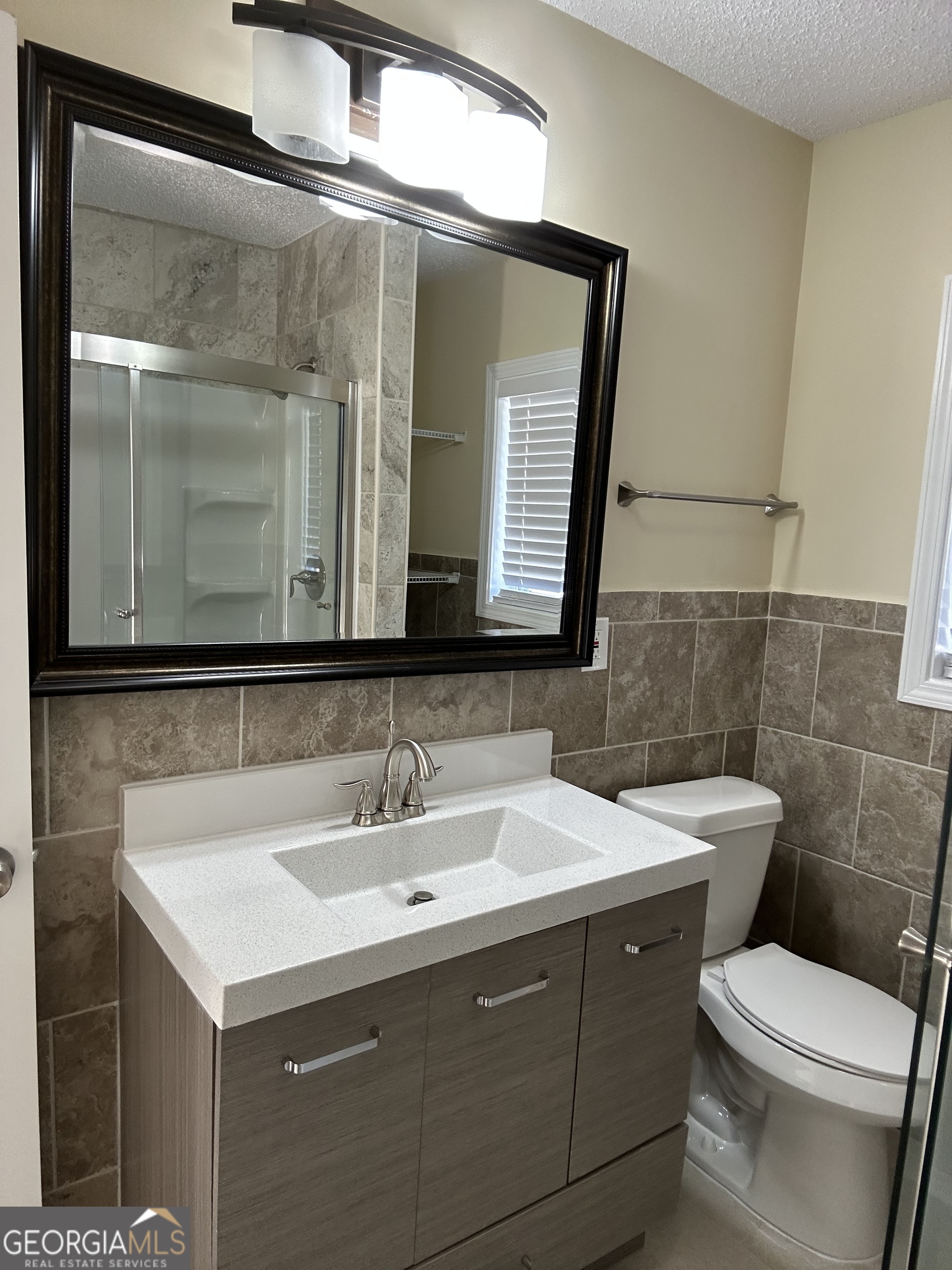 306 Garner Street Thomaston, GA 30286 - Photo 11 of 59 a bathroom with a toilet sink and mirror