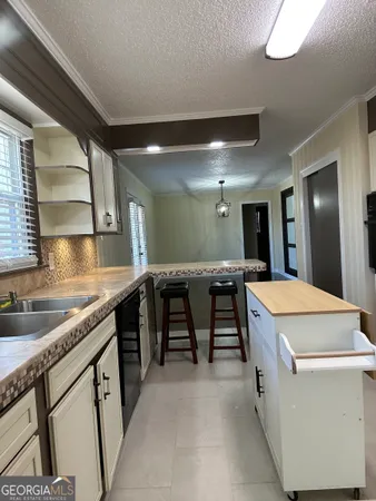 a kitchen with a sink stove and cabinets