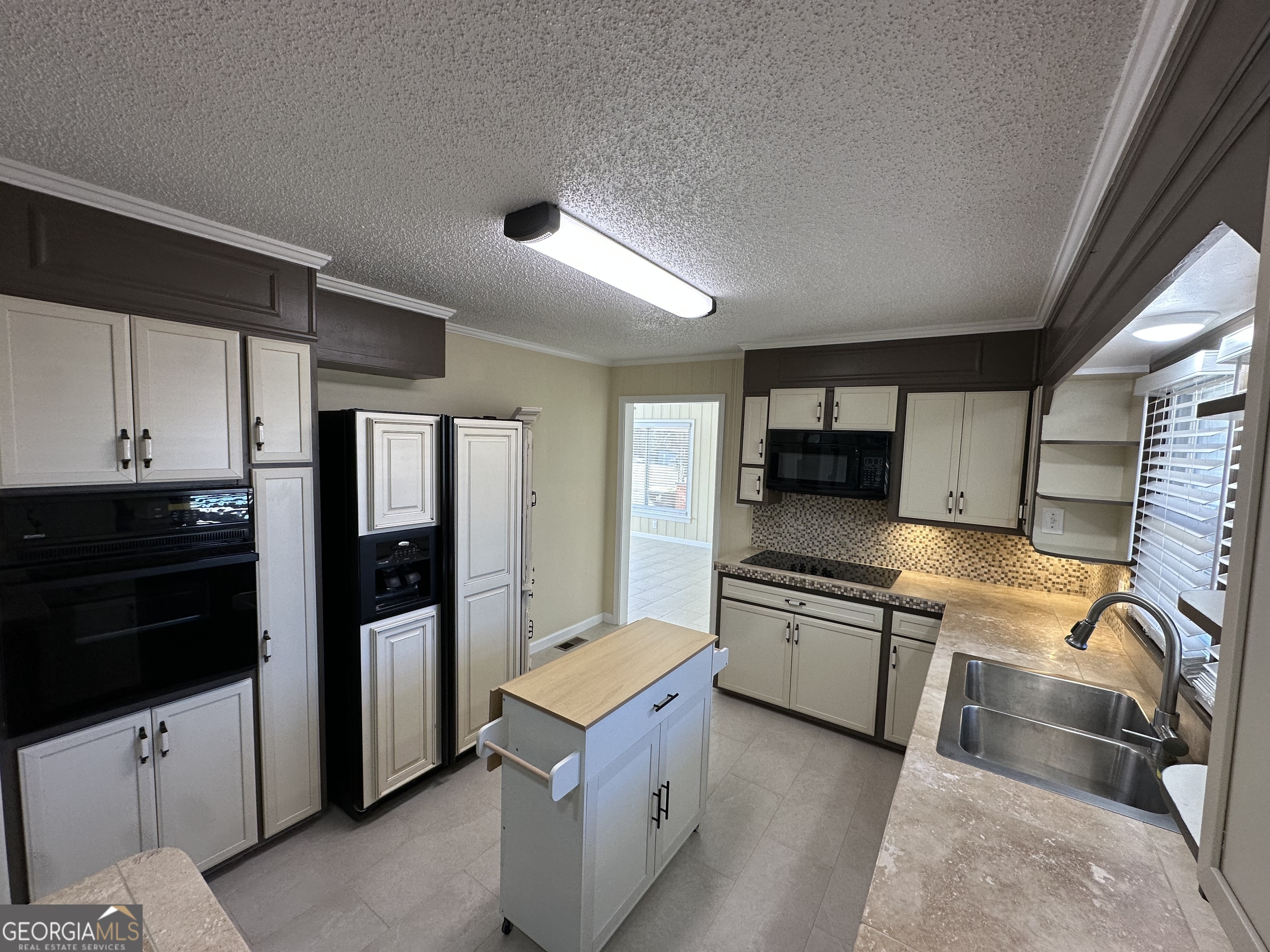 306 Garner Street Thomaston, GA 30286 - Photo 22 of 59 a kitchen with stainless steel appliances granite countertop a refrigerator and a stove top oven