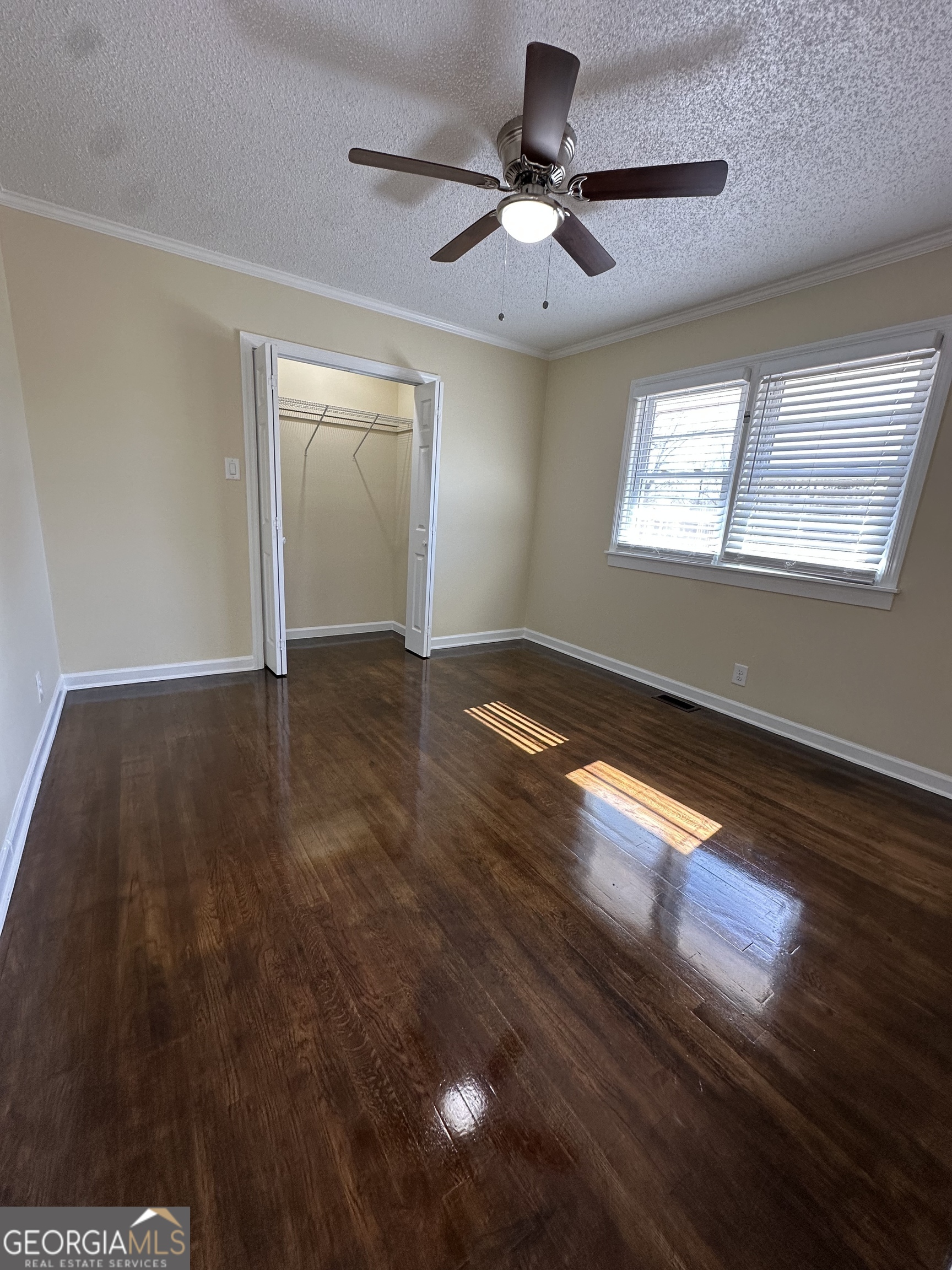 306 Garner Street Thomaston, GA 30286 - Photo 29 of 59 a view of an empty room with wooden floor and a window