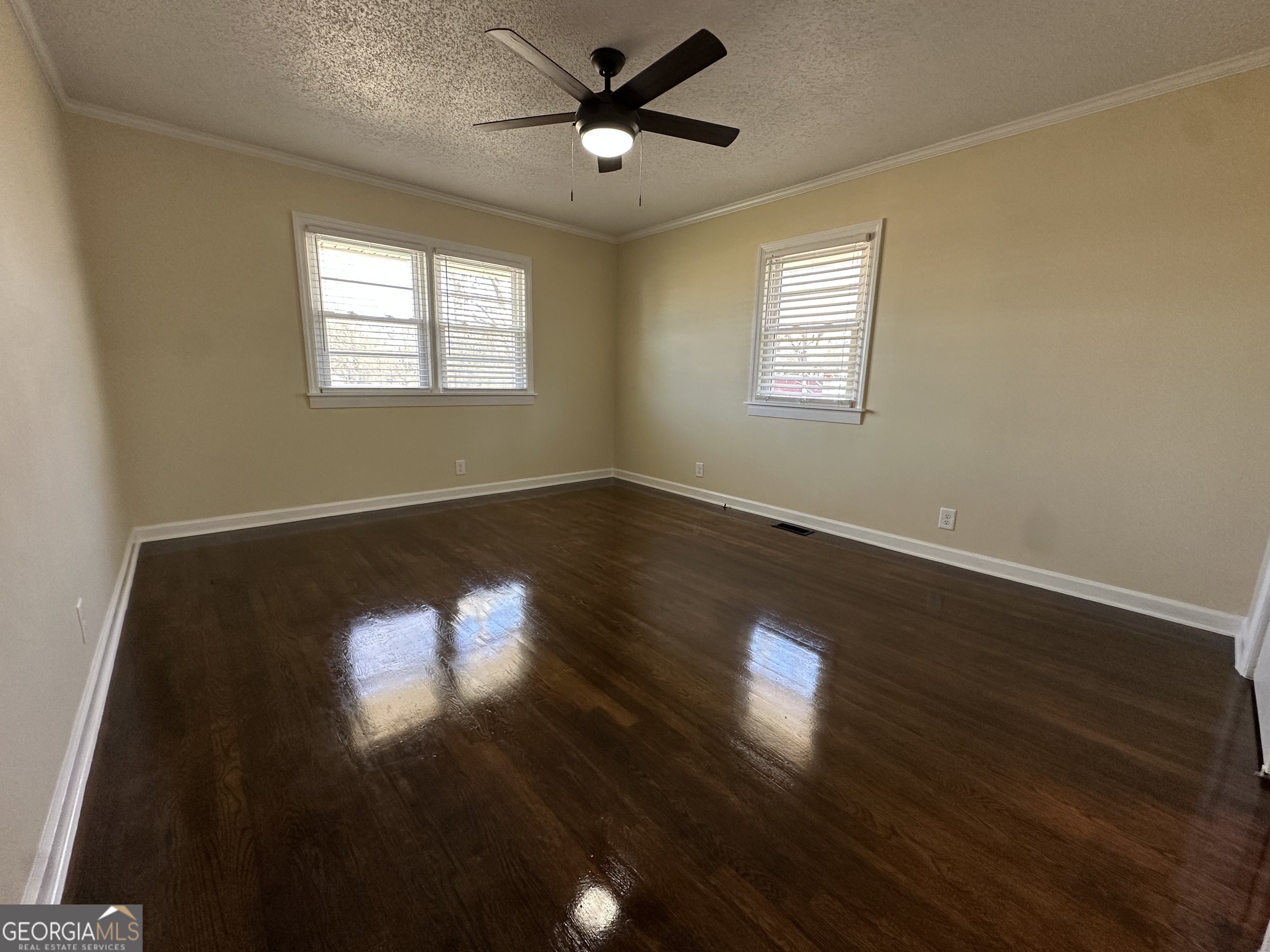 306 Garner Street Thomaston, GA 30286 - Photo 30 of 59 a view of empty room with wooden floor and fan