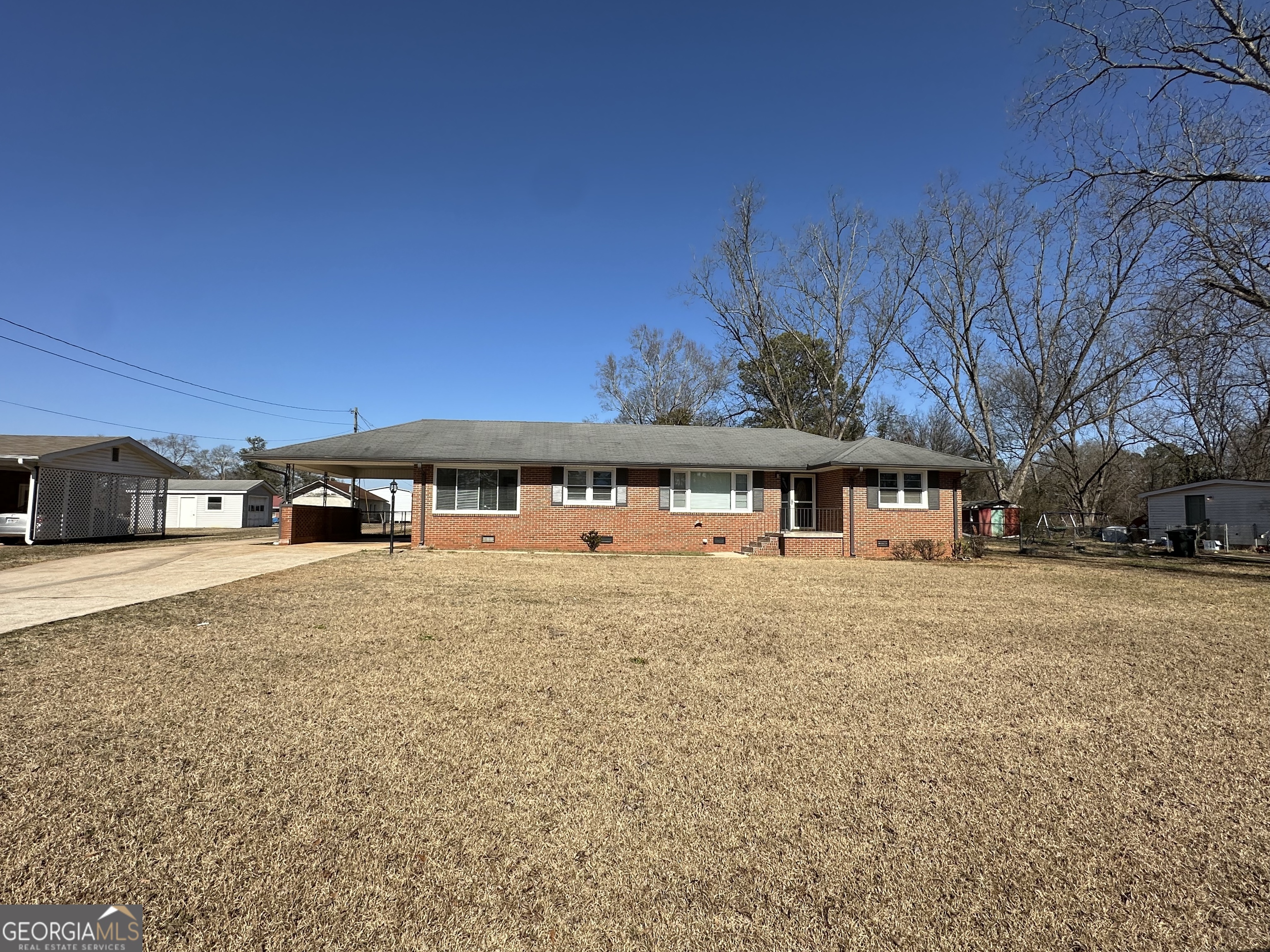 306 Garner Street Thomaston, GA 30286 - Photo 3 of 59 a front view of a house with a yard