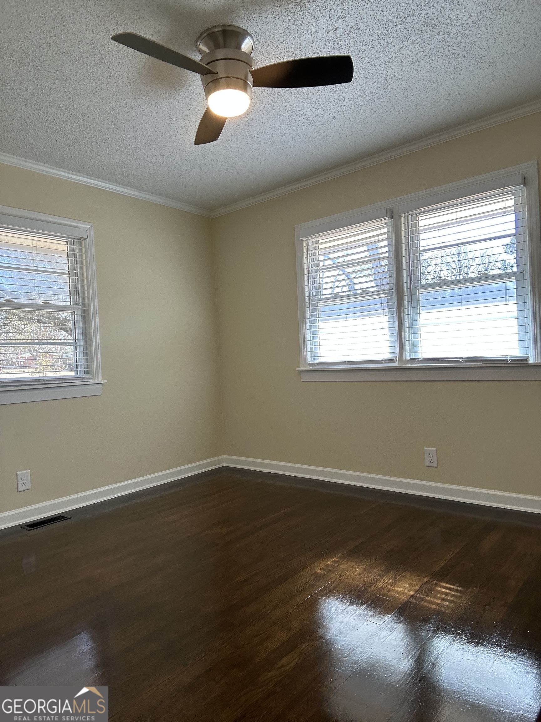 306 Garner Street Thomaston, GA 30286 - Photo 35 of 59 a view of an empty room with wooden floor and a window