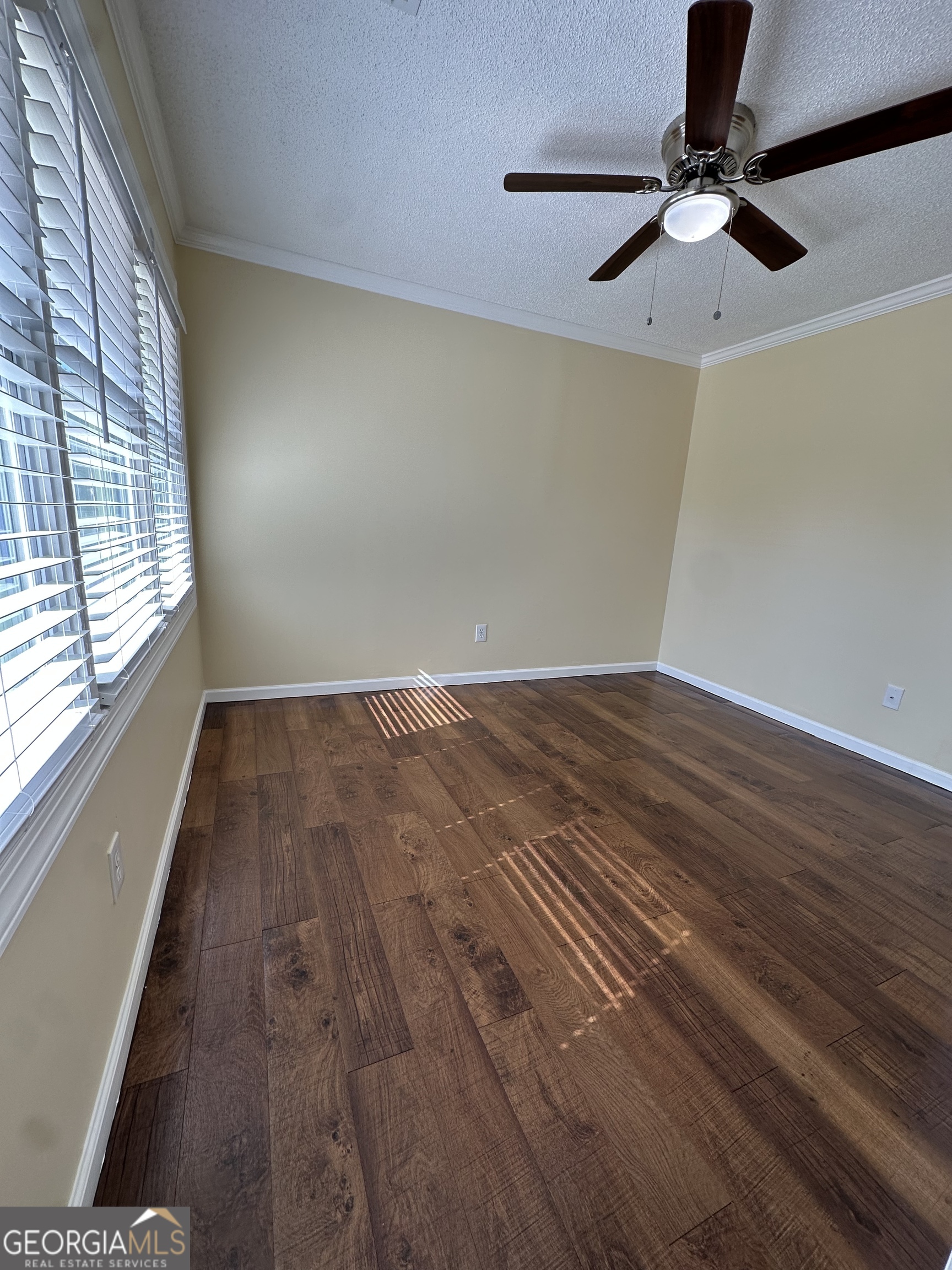 306 Garner Street Thomaston, GA 30286 - Photo 42 of 59 a view of empty room with wooden floor and fan