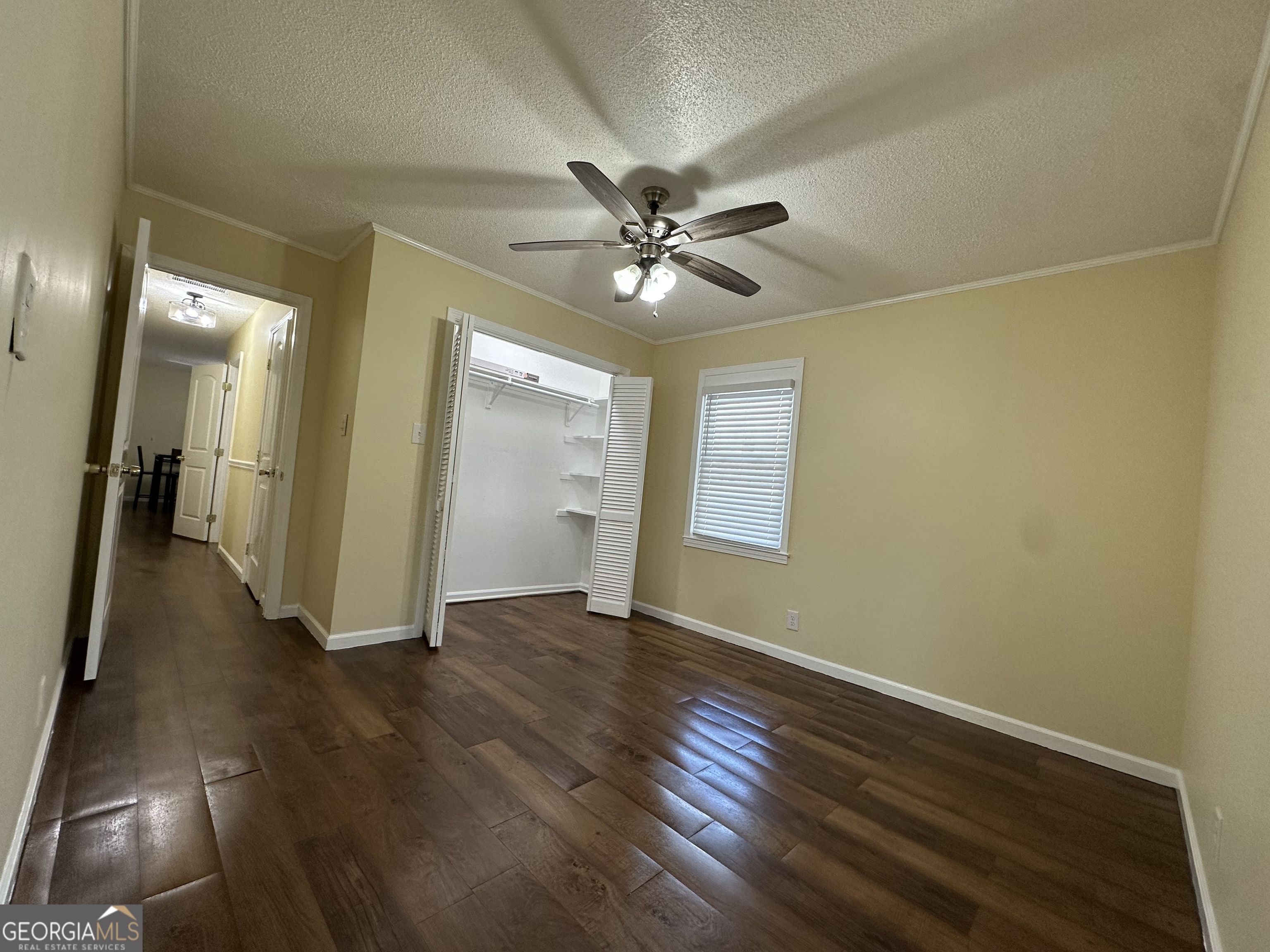 306 Garner Street Thomaston, GA 30286 - Photo 45 of 59 an empty room with wooden floor and windows