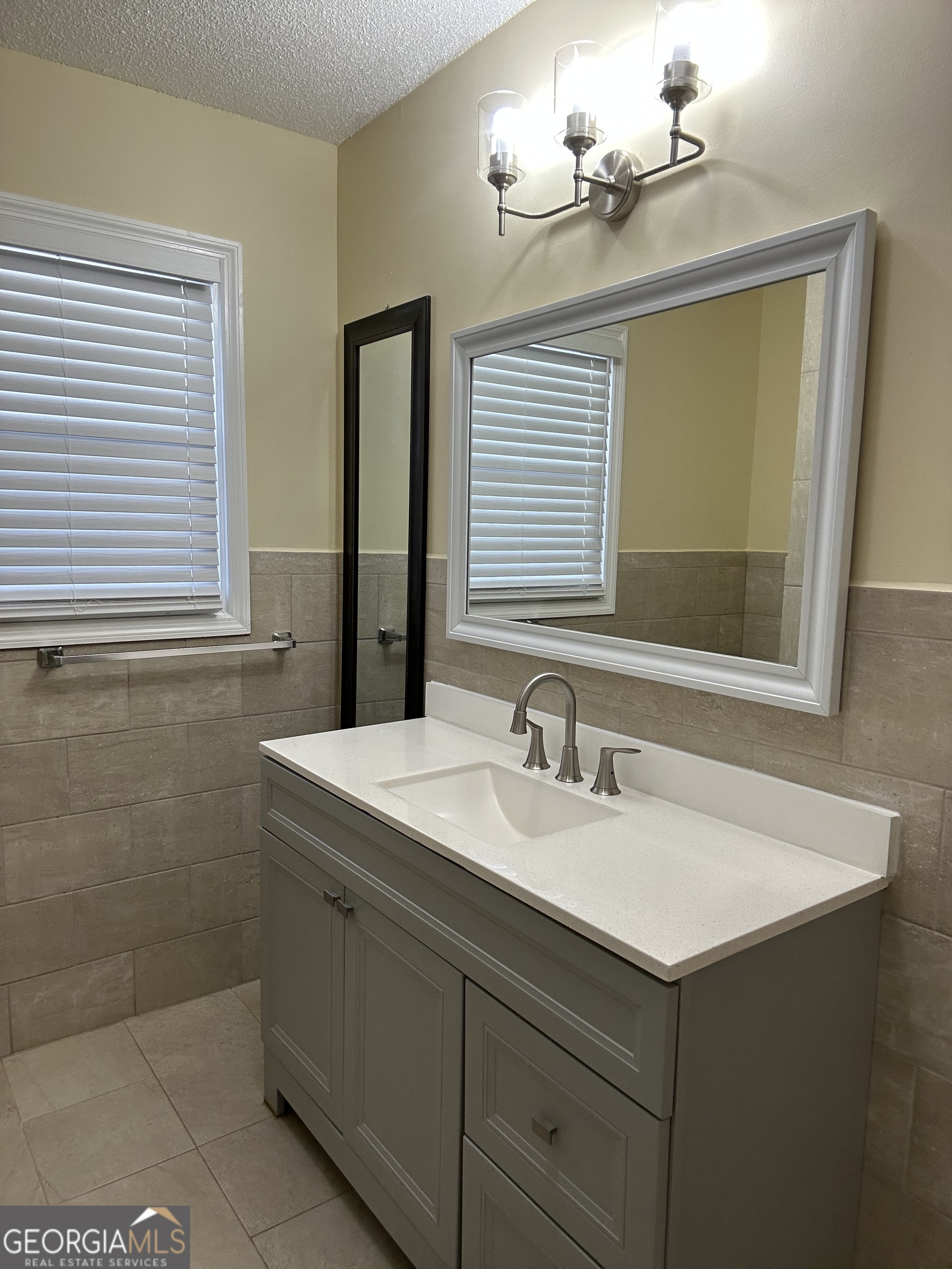 306 Garner Street Thomaston, GA 30286 - Photo 48 of 59 a bathroom with a sink vanity and a mirror