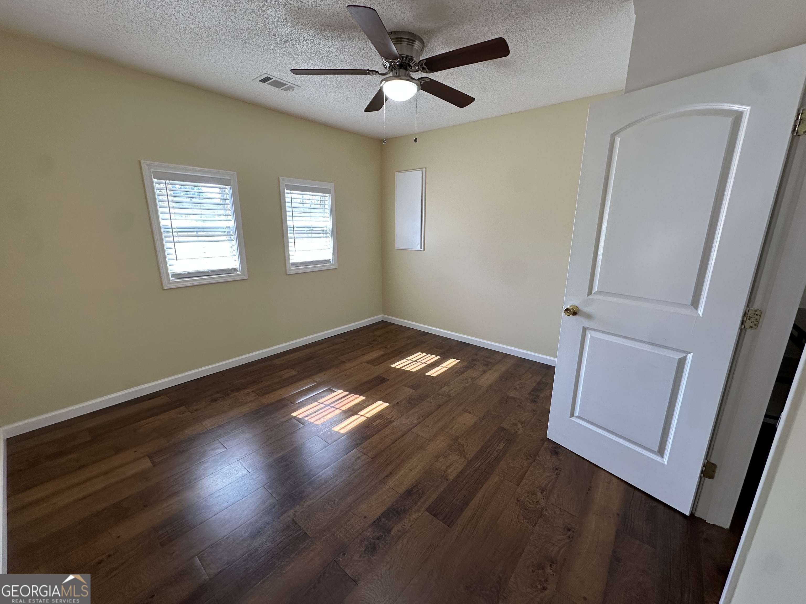 306 Garner Street Thomaston, GA 30286 - Photo 54 of 59 a view of empty room with wooden floor and fan