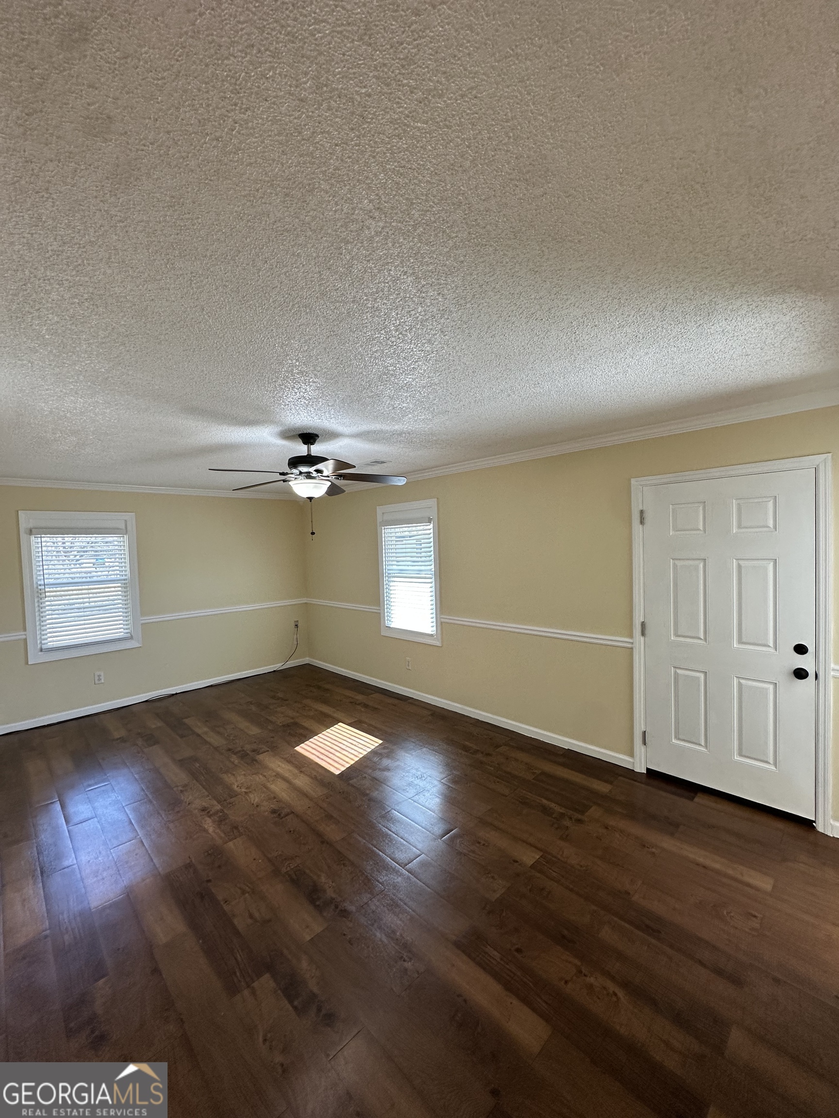 306 Garner Street Thomaston, GA 30286 - Photo 58 of 59 a view of an empty room with wooden floor