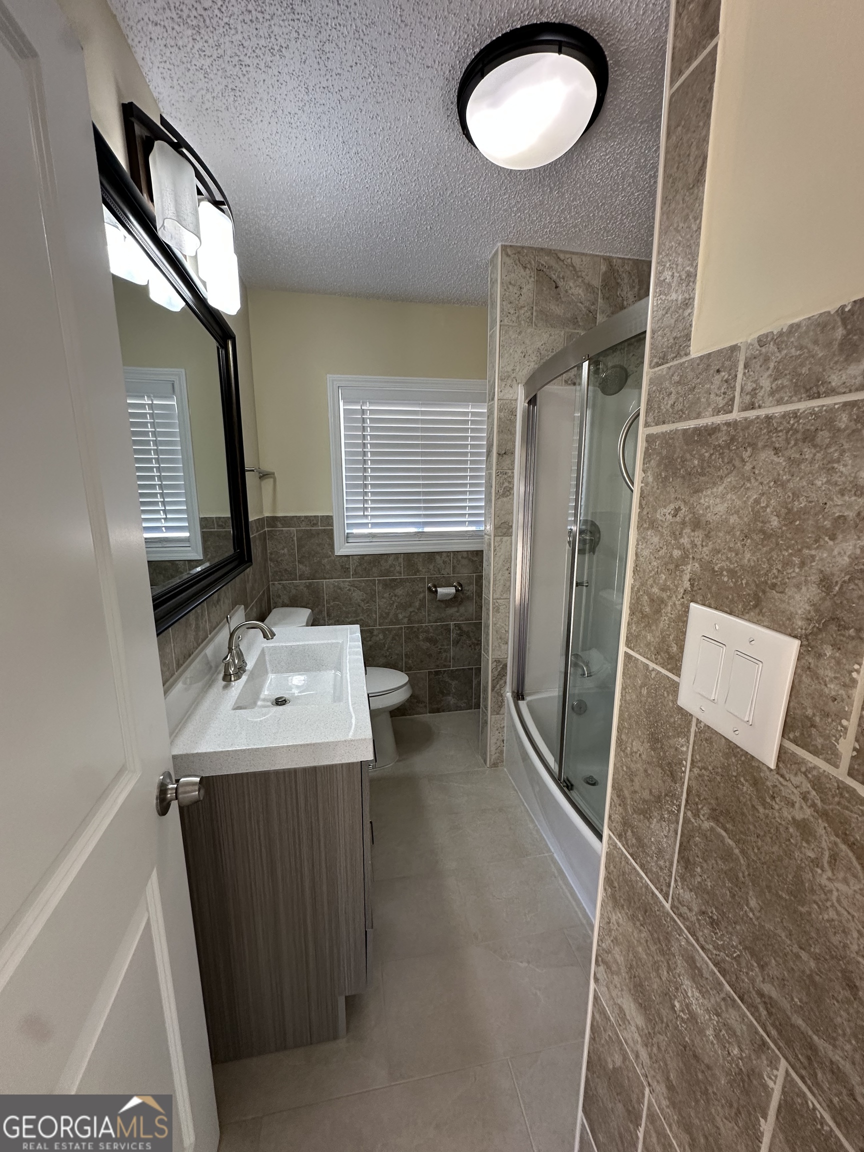 306 Garner Street Thomaston, GA 30286 - Photo 10 of 59 a bathroom with a sink a toilet and mirror