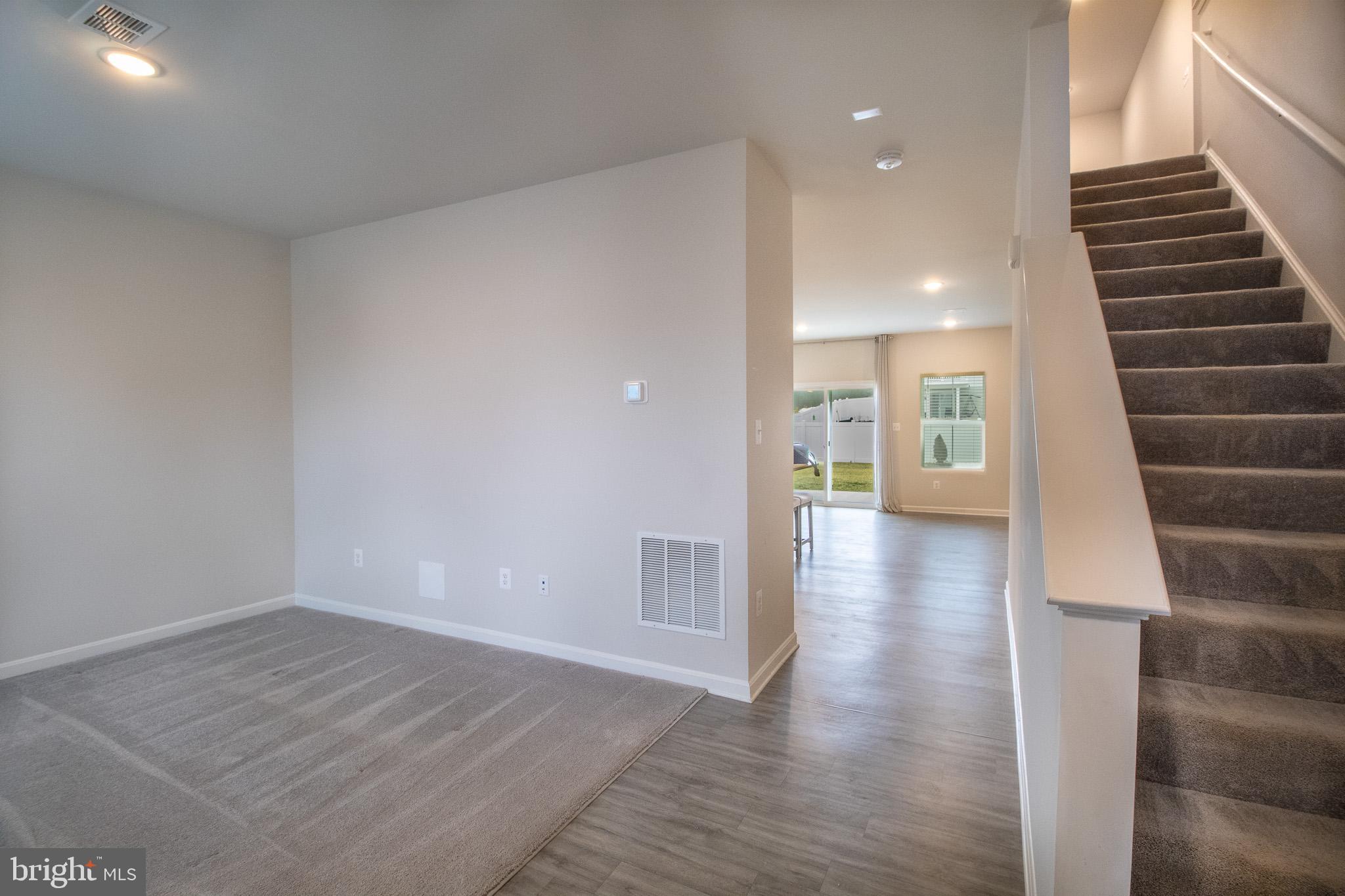 154 Diving Scaup Road Hedgesville, WV 25427 - Photo 13 of 57 a view of a hallway with wooden floor and staircase