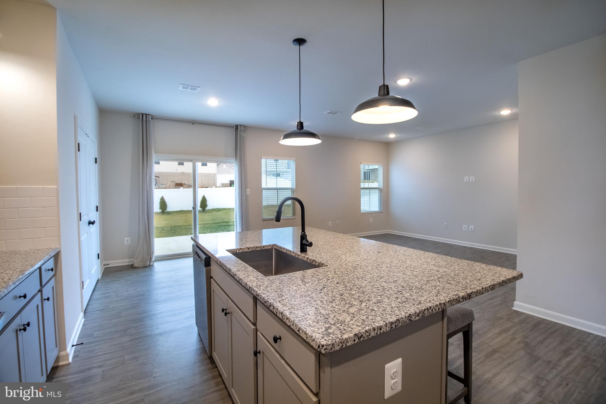 154 Diving Scaup Road Hedgesville, WV 25427 - Photo 22 of 57 a kitchen with granite countertop kitchen island a sink and a wooden floor