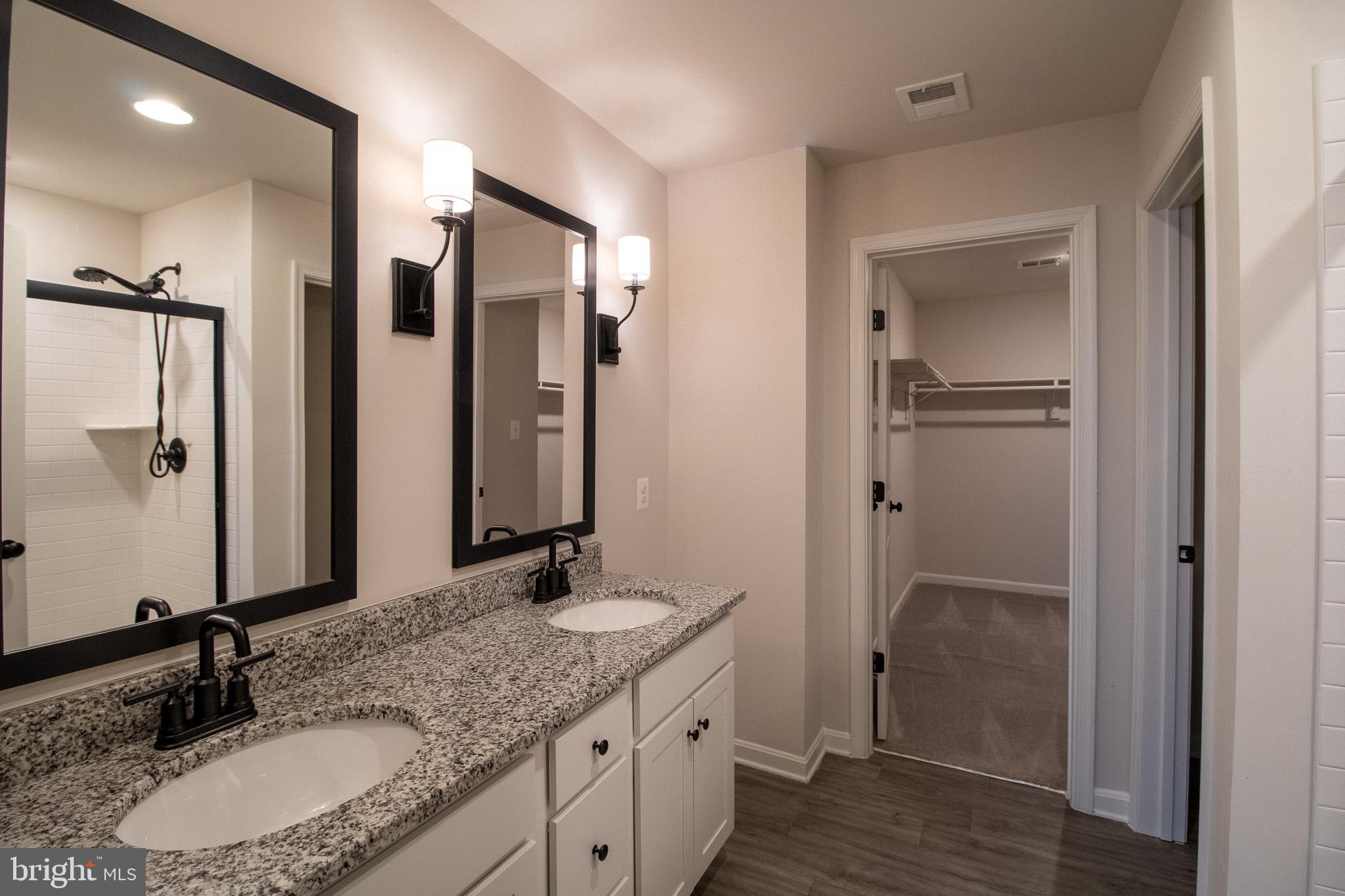 154 Diving Scaup Road Hedgesville, WV 25427 - Photo 38 of 57 a bathroom with a granite countertop sink and a mirror