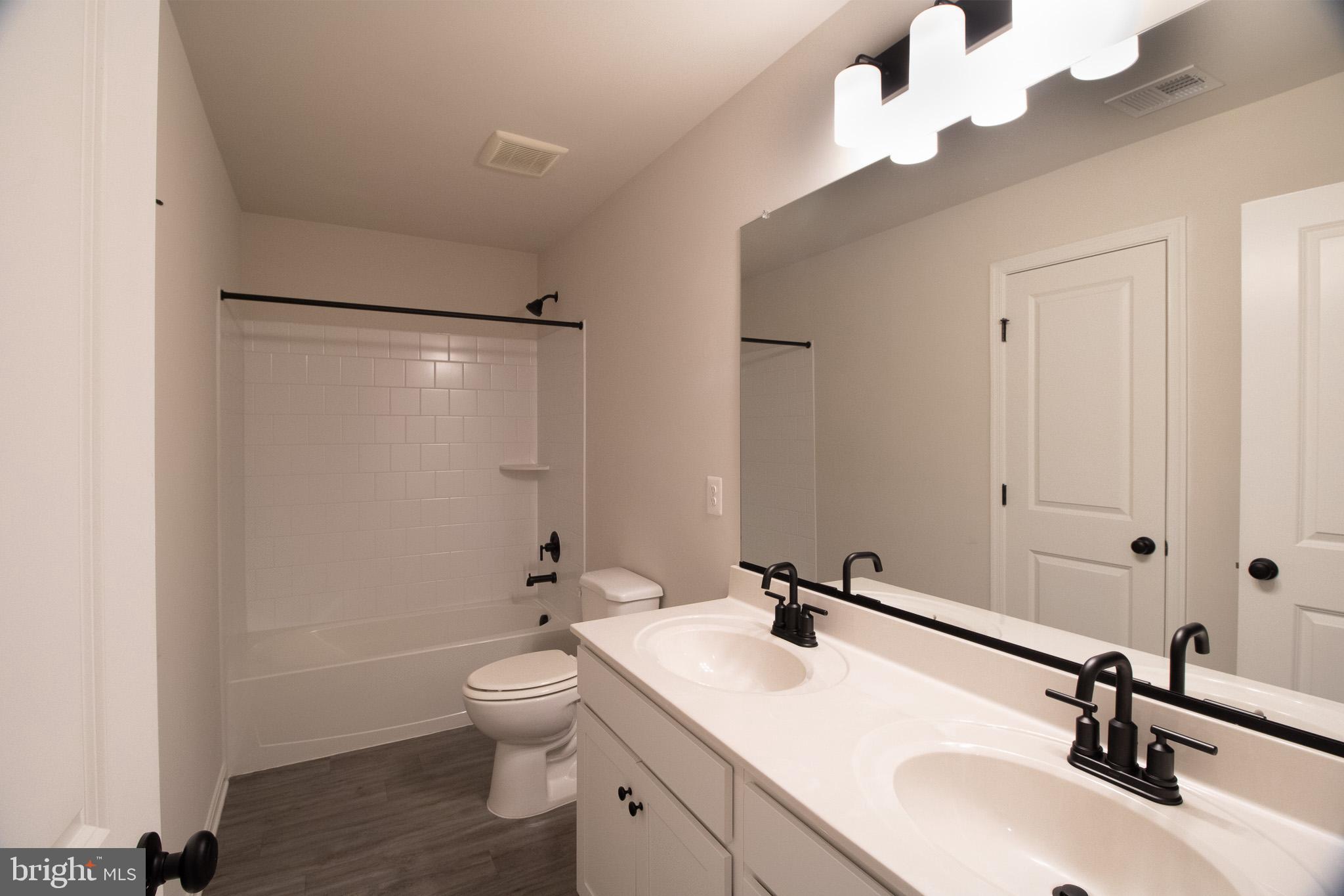 154 Diving Scaup Road Hedgesville, WV 25427 - Photo 46 of 57 a bathroom with a sink a toilet and a mirror