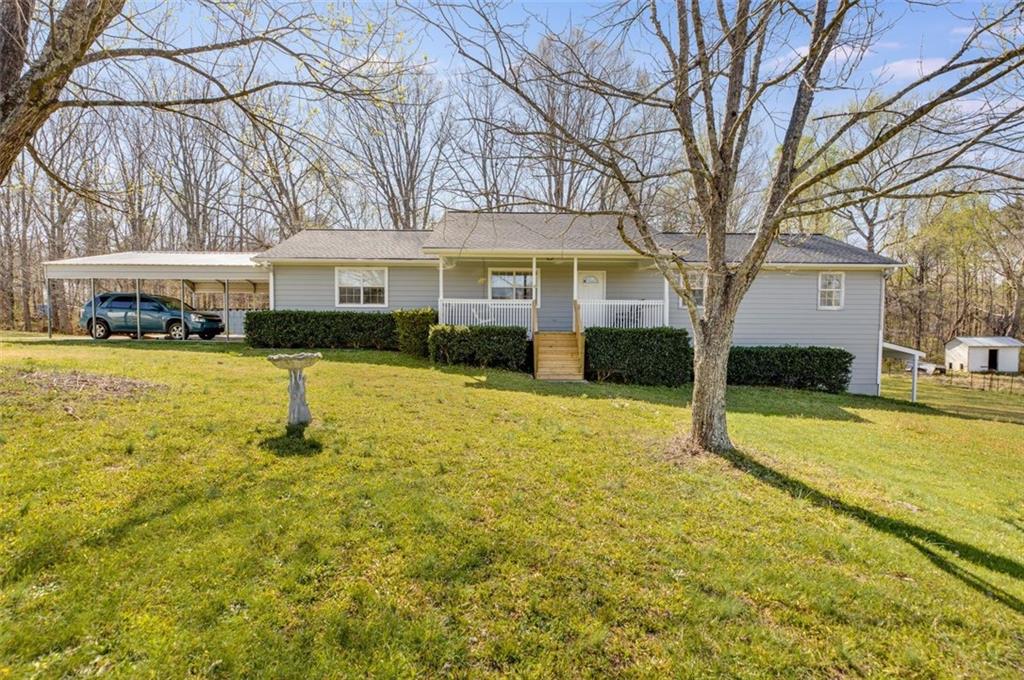 a view of a house with swimming pool and a yard