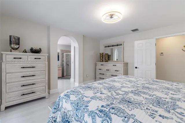 a bathroom with a double vanity sink toilet and shower
