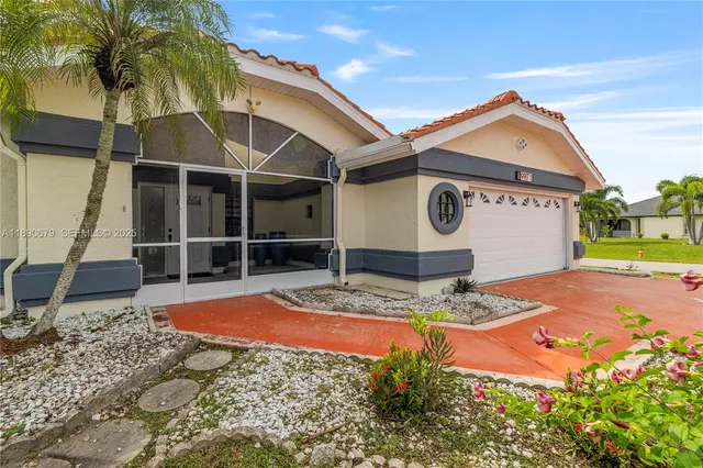 a front view of a house with garden