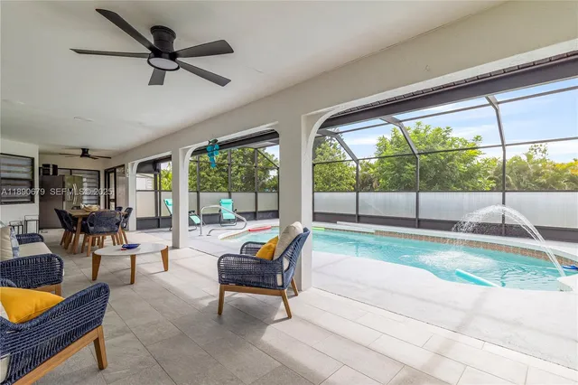 a view of a dining room and livingroom with furniture wooden floor and a rug