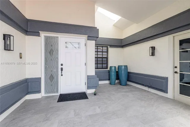 an aerial view of residential houses with outdoor space and a lake view