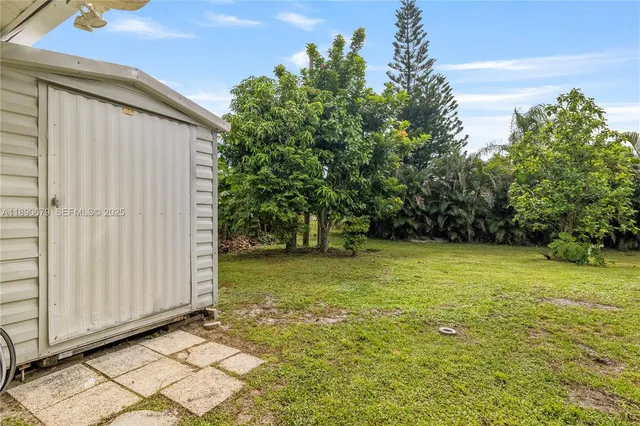 an aerial view of a house with a garden and lake view