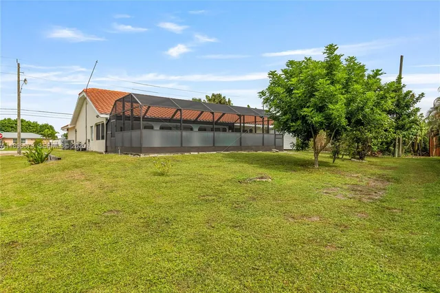 an aerial view of a house with outdoor space lake view