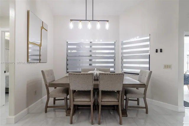 a view of a dining room with furniture and window