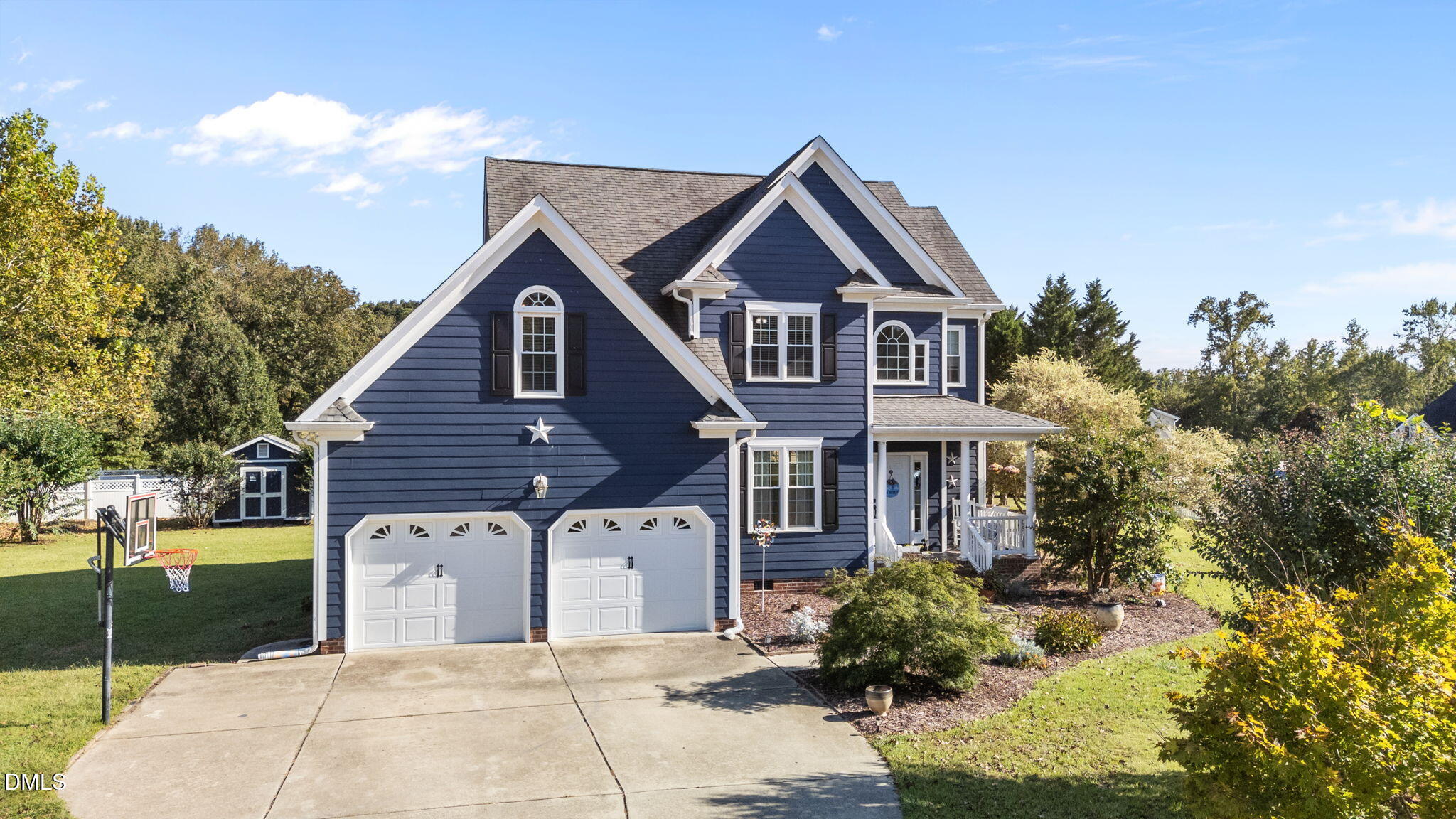 1617 Kendall Hill Road Willow Spring, NC 27592 - Photo 6 of 58 a front view of a house with garden