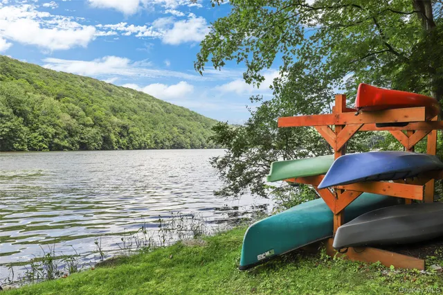 a view of a house with a backyard and sitting area