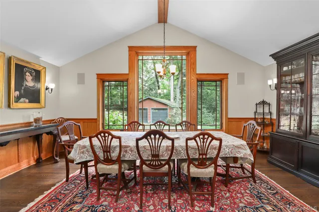 a view of a dining room with furniture wooden floor and a chandelier
