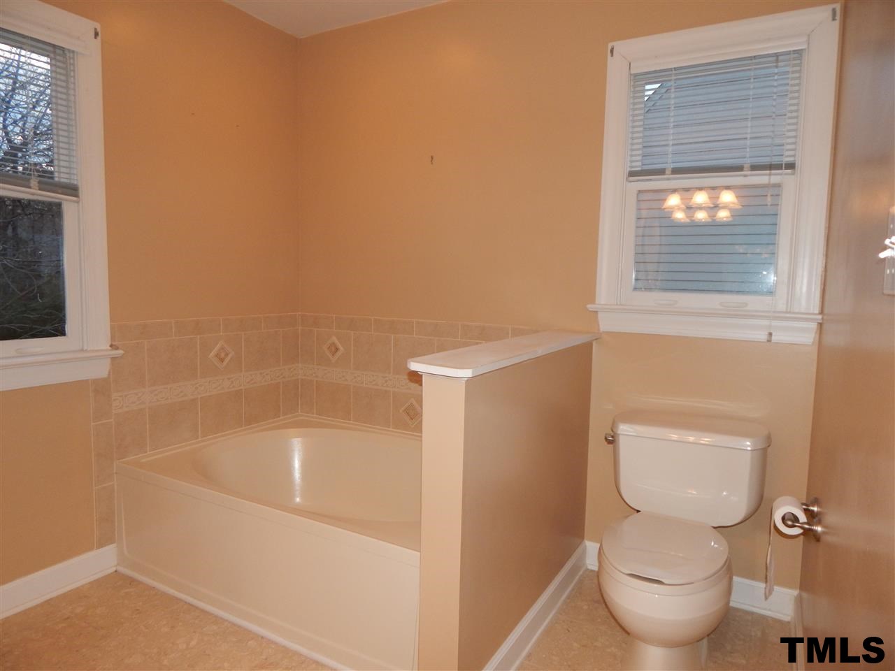 4121 Fowler Ridge Drive Raleigh, NC 27616 - Photo 14 of 20 a white toilet sitting next to a bathroom sink