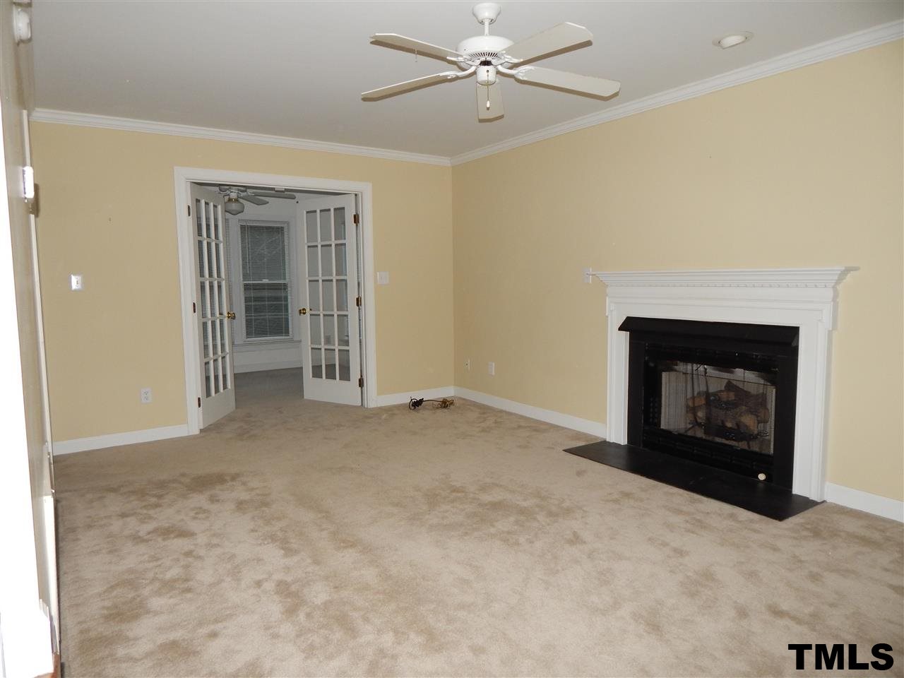 4121 Fowler Ridge Drive Raleigh, NC 27616 - Photo 7 of 20 a view of an empty room with a fireplace