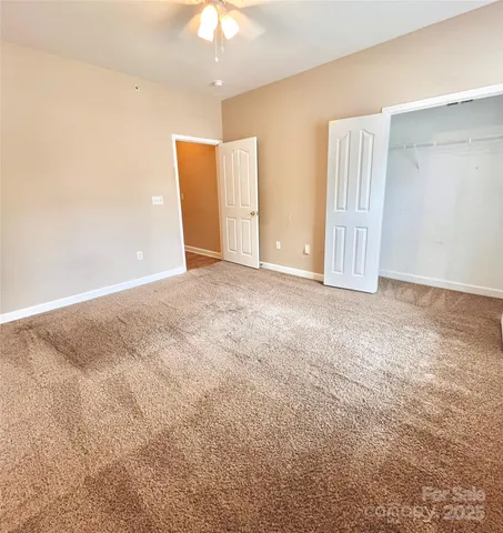 a view of a livingroom with a ceiling fan and window