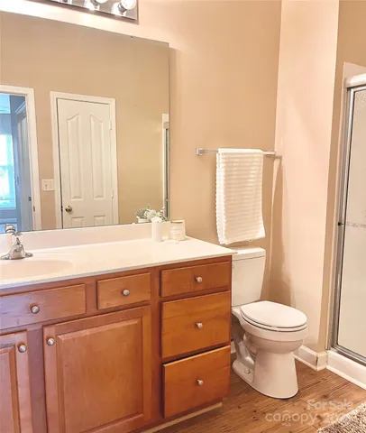 a spacious bathroom with a granite countertop sink toilet and shower