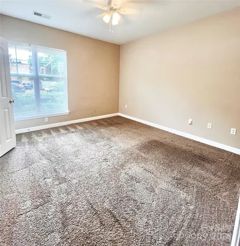 an empty room with windows and closet