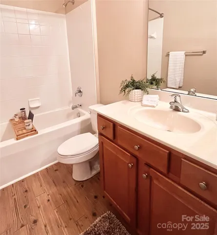 a bathroom with a sink a toilet and bathtub