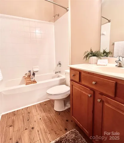 a kitchen with stainless steel appliances kitchen island wooden cabinets a stove a sink and a refrigerator