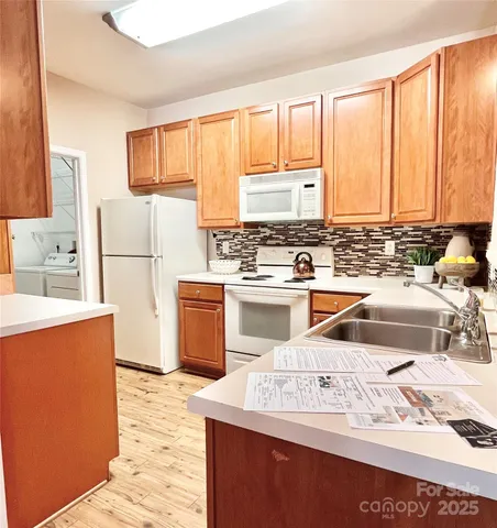 a kitchen with stainless steel appliances granite countertop a sink stove and cabinets