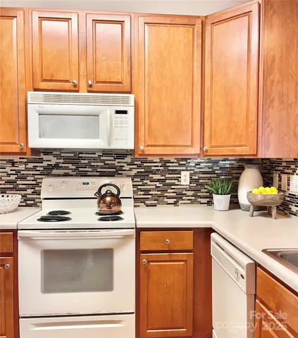 a kitchen with appliances cabinets and a counter top space