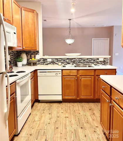 a kitchen with stainless steel appliances granite countertop a sink stove and white cabinets