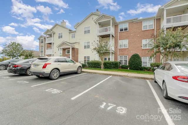 a view of a white car parked in front of a brick house