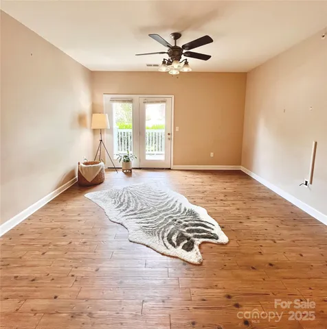 a view of a livingroom with hardwood floor and a window