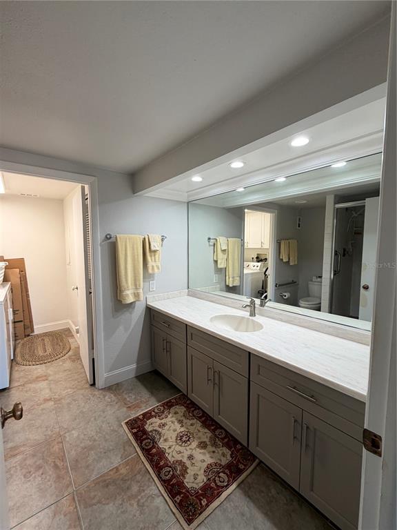 50 Coe Road, Unit 322 Belleair, FL 33756 - Photo 13 of 22 a large bathroom with a sink and a mirror