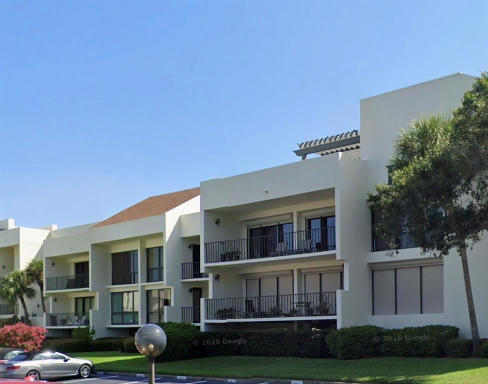 50 Coe Road, Unit 322 Belleair, FL 33756 - Photo 3 of 22 a front view of a house with garden