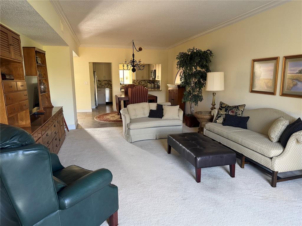 50 Coe Road, Unit 322 Belleair, FL 33756 - Photo 7 of 22 a living room with furniture and a flat screen tv
