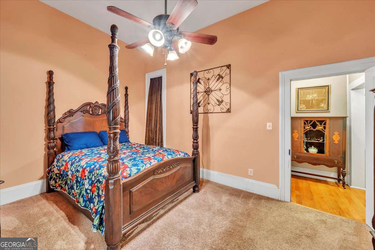212 East Union Street Vienna, GA 31092 - Photo 26 of 62 a bedroom with bed and paintings on the wall