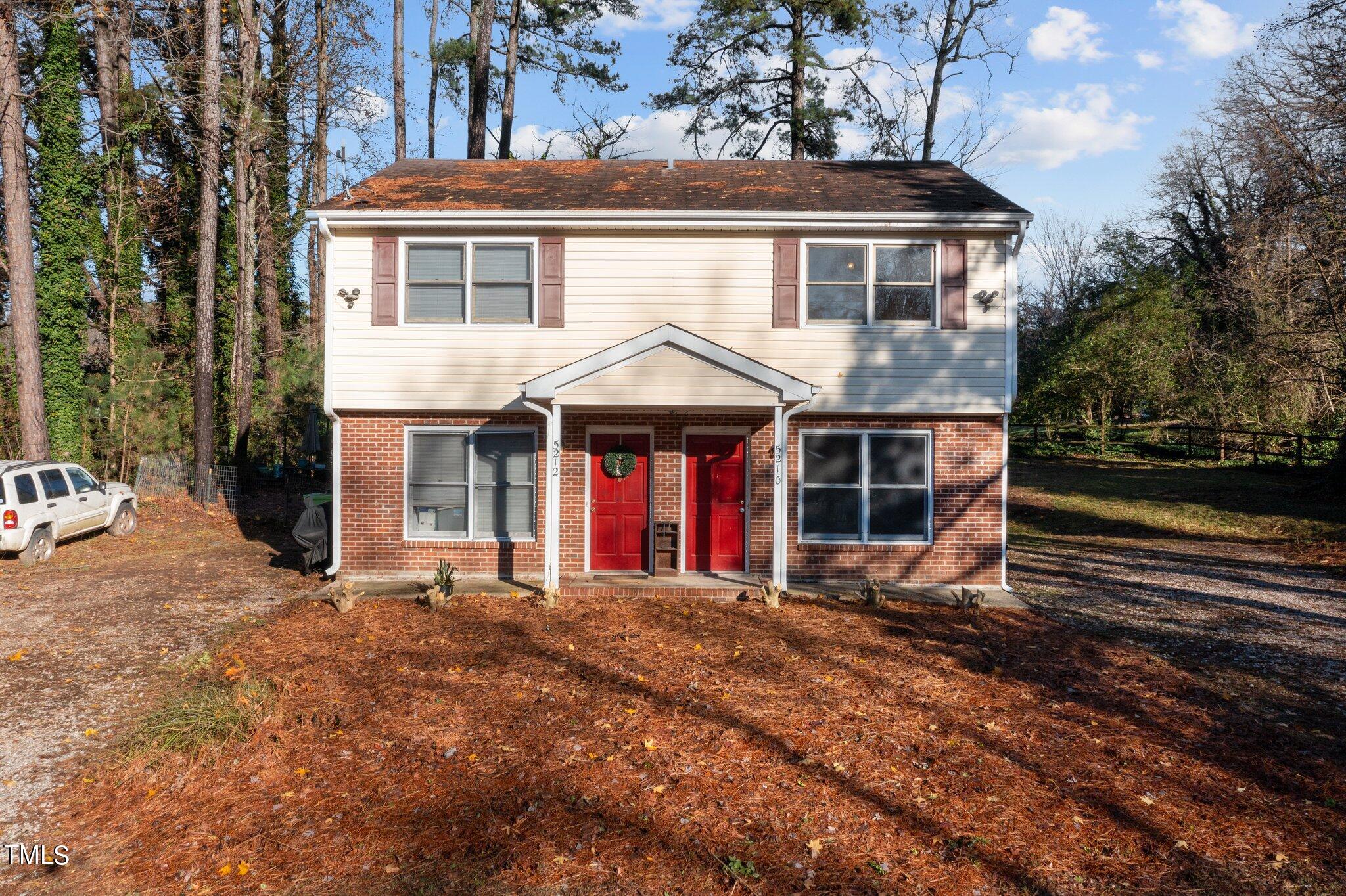 5210 Vann Street Raleigh, NC 27606 - Photo 2 of 28 a front view of a house with a yard