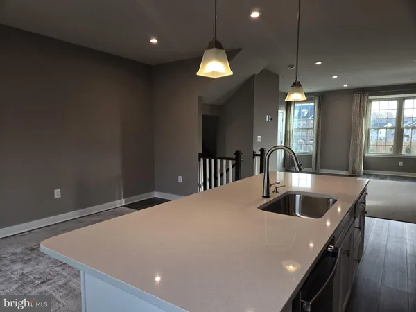 a large kitchen with kitchen island granite countertop a stove a sink a refrigerator and a fireplace